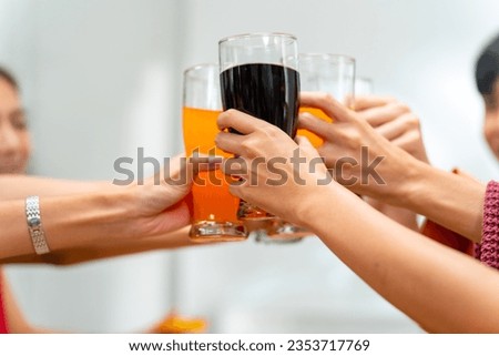 Group of Young Asian man and woman friends having dinner party eating food and drinking soft drink together at home. Happy people friends have fun reunion meeting celebration party on holiday vacation