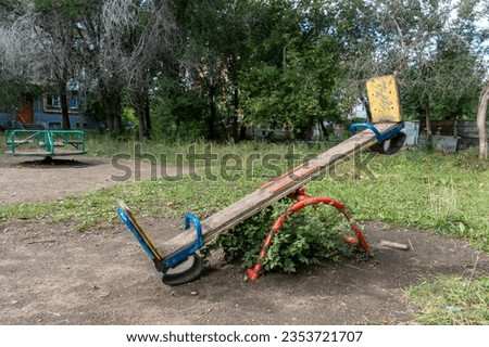 Seesaw and merry go round in playground Royalty-Free Stock Photo #2353721707