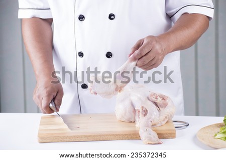 Chef holding the raw chicken before cooking 