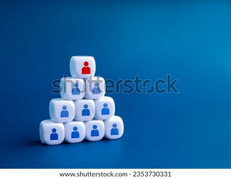 Leadership, leader, manager, followers, business team concepts. Red person icon on the top among of many blue people symbol on white blocks building as a pyramid shape isolated on blue background. Royalty-Free Stock Photo #2353730331