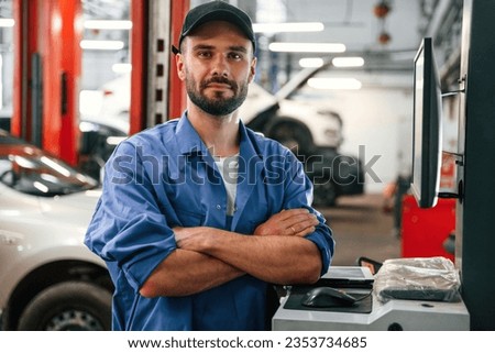 Standing with arms crossed. Auto mechanic working in garage. Repair service. Royalty-Free Stock Photo #2353734685