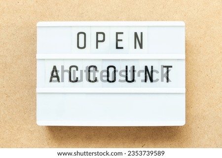 Lightbox with word open account on wood background