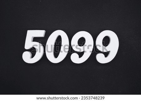 Black for the background. The number 5099 is made of white painted wood.