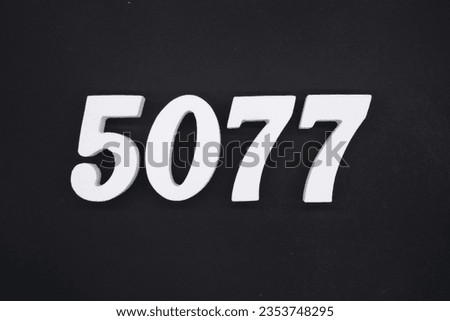 Black for the background. The number 5077 is made of white painted wood.
