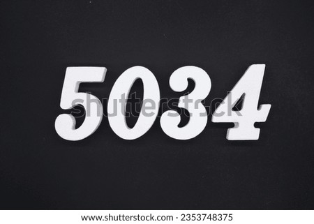 Black for the background. The number 5034 is made of white painted wood.