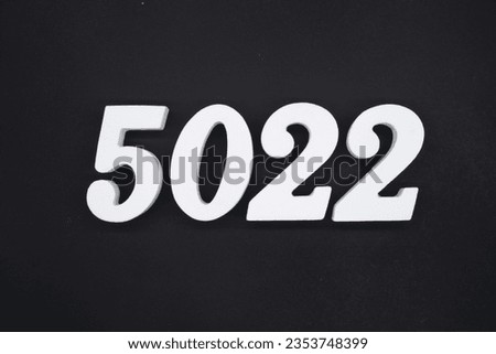 Black for the background. The number 5022 is made of white painted wood.