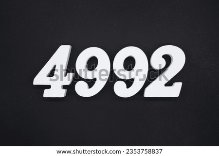 Black for the background. The number 4992 is made of white painted wood.