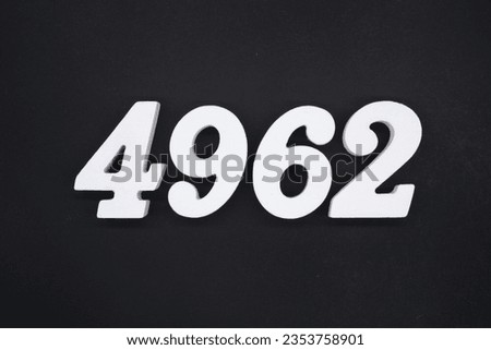 Black for the background. The number 4962 is made of white painted wood.