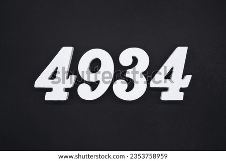 Black for the background. The number 4934 is made of white painted wood.