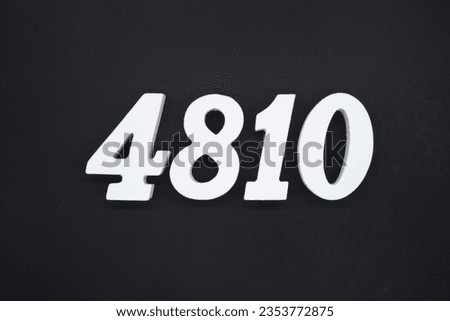 Black for the background. The number 4810 is made of white painted wood.