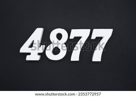 Black for the background. The number 4877 is made of white painted wood.