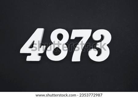 Black for the background. The number 4873 is made of white painted wood.