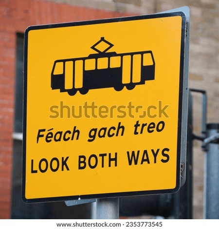 Yellow "Look both ways" street sign in english and irish gaelic language