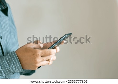 Male hand using mobile phone, smartphone, shampoo, talking, business concept.