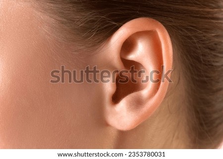 Close-up image of female ear. Taking care after health, visiting doctors, check up. Concept of female beauty, skin care, cosmetology and cosmetics, health, ad Royalty-Free Stock Photo #2353780031