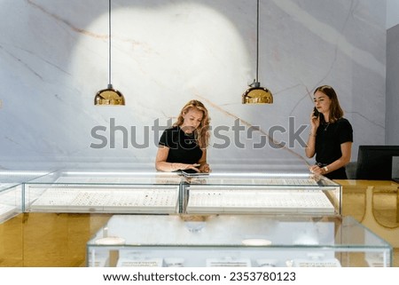 Young businesswoman shop owner doing online selling of jewelry in jewelry boutique. Luxury jewelry store concept. Royalty-Free Stock Photo #2353780123