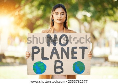 Woman, poster and save planet sign at park for climate change, environment and green eco friendly protest. Young person in portrait and nature, earth or globe support for sustainable world and action Royalty-Free Stock Photo #2353782577