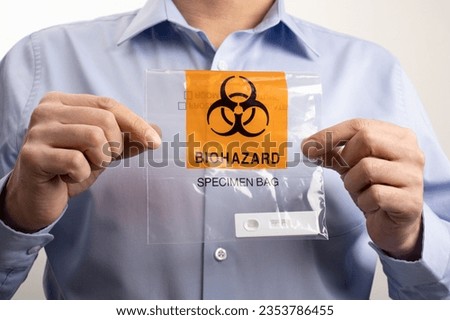 Office worker holding Biohazard Specimen Bag with Positive PCR Antigen Test, biohazard pandemic concept