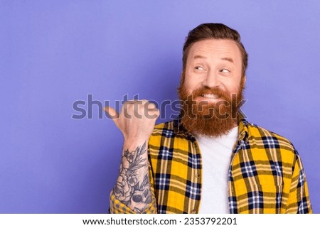 Photo portrait of funny tricky bearded guy hipster direct thumb finger empty space news banner isolated purple color background