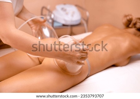 Vacuum Therapy for Buttocks, sports anti-cellulite massage with vacuum therapy machine on beige background