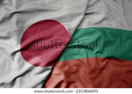 big waving national colorful flag of japan and national flag of bulgaria . macro