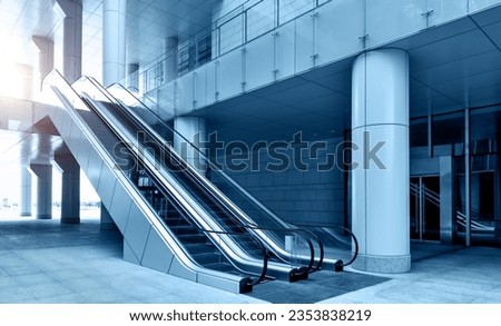 Two escalators in modern office building Royalty-Free Stock Photo #2353838219