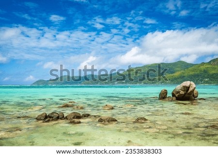 View of nice tropical beach with palms and granite rocks. Holiday and vacation concept. Tropical beach. Mahe Island, Seychelles. Anse Roayle