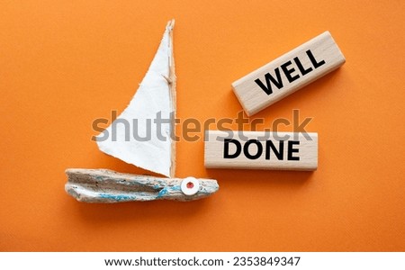 Well done symbol. Wooden blocks with words Well done. Beautiful orange background with boat. Business and Well done concept. Copy space.