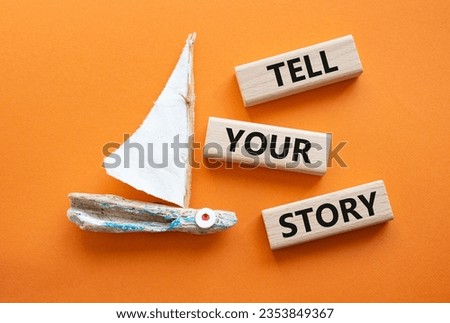 Tell your story symbol. Wooden blocks with words Tell your story. Beautiful orange background with boat. Business and Tell your story concept. Copy space.