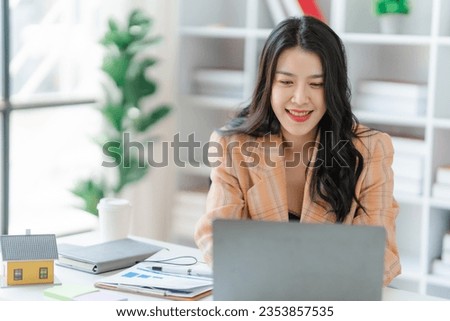 Asian woman working through laptop. business woman busy working with laptop computer at office