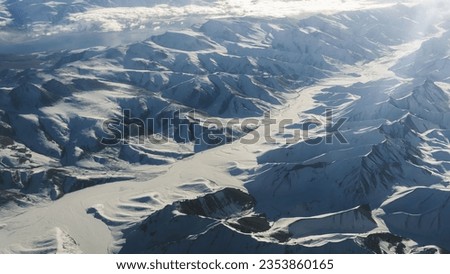 Winter Wonderland in Ladakh: Serene Snow-Covered Mountains Amidst Tranquil Beauty. 
