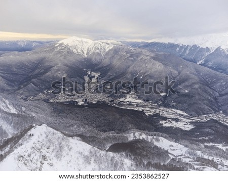 View of the winter sunset and snow-covered mountains in Sochi