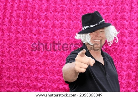Photo Booth. A man Wears Crazy Props and Poses for his pictures to be taken in a Photo Booth at a party. People love Photo Booths at Parties and Weddings. Everyone gets Pictures Printed. Photo Booth.
