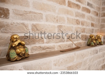 incense stick with buddha figures on a stone background