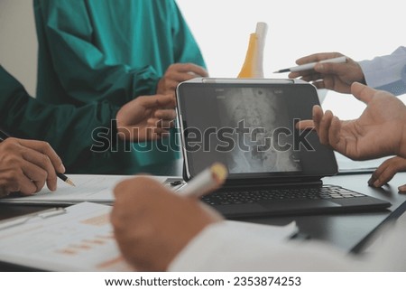 Group of doctors reading a document in meeting room at hospital