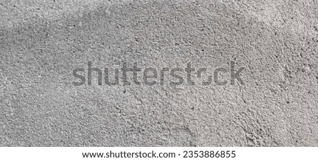 Photo of the rough surface of an old and dirty exterior concrete wall of a house suitable for background and wallpaper.