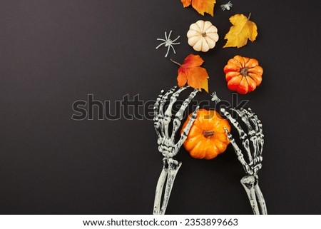 Crafting an atmosphere of chills with creepy Halloween decorations. Top view of skeleton hands, colorful pumpkins, autumn leaves, creepy decorations on black background with marketing space