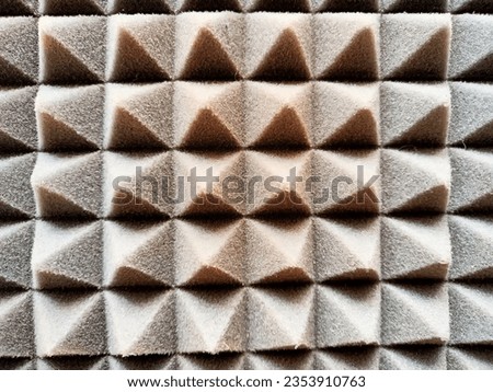 Foam soft texture and background with lots of pyramids, triangles. Frame, place for text and copy space. The difference of light and shadow
