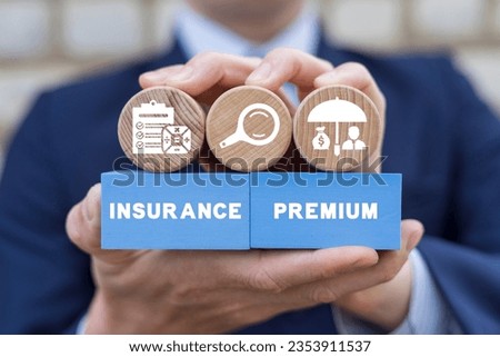 Businessman holding colorful blocks with icons and inscription: INSURANCE PREMIUM. Insurance premium business service concept. Money, life, car, house, health insured. Royalty-Free Stock Photo #2353911537