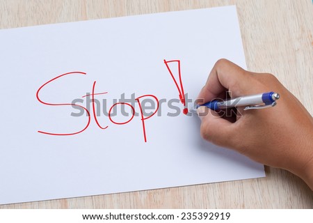 Hand writing stop on paper