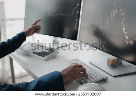Stock investor, business man is trading stocks for profit, stock market oscillating graph screen, investment management, analyzing profit trading in stocks. Concept of investing in stocks.