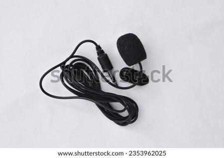 Professional lavalier microphone close-up, perfect for high-quality audio recording. Precise and professional audio recording and production concept.