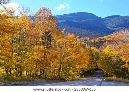 Autumn colors at the start of Smuggler's Notch with Mount Mansfield behind, Vermont, USA Royalty-Free Stock Photo #2353969655