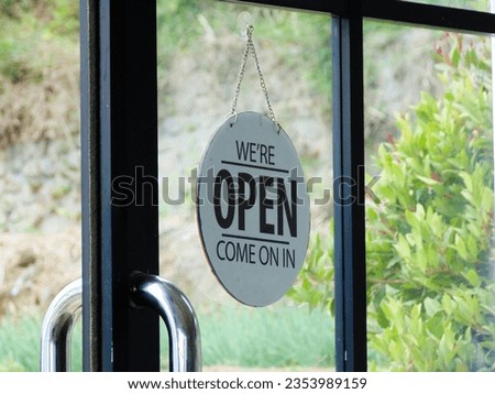 Open sign hanging on the glass door