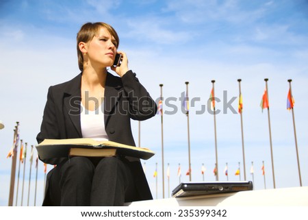 business woman with book and mobile phone