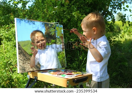 funny kid draws a picture on the mirror