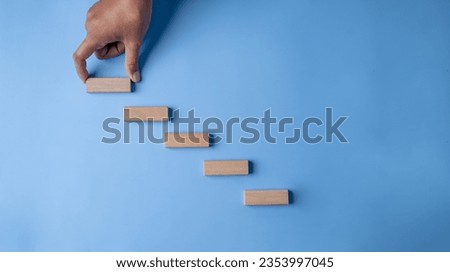 climb, goal, stair, icon, pointing, hand, blue, endeavor, background, attempt. sorting woodchip to create stair for climbing to make easy, hit the goal and mission. behind background color is blue.