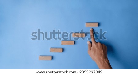 climb, goal, stair, icon, pointing, hand, blue, endeavor, background, attempt. use finger to pointing at stair for climbing hit the goal and mission. background is blue then icon and symbol dont show.
