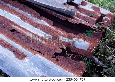 Rusted galvanized roofing sheets iron rust old background textured. Royalty-Free Stock Photo #2354004709