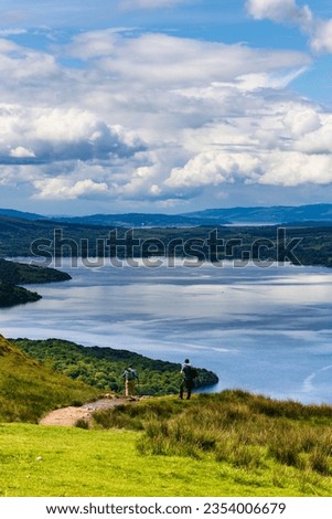 Hikers descending Conic Hill towards Loch Lomond with beautiful mountain scenery (Balmaha) Royalty-Free Stock Photo #2354006679